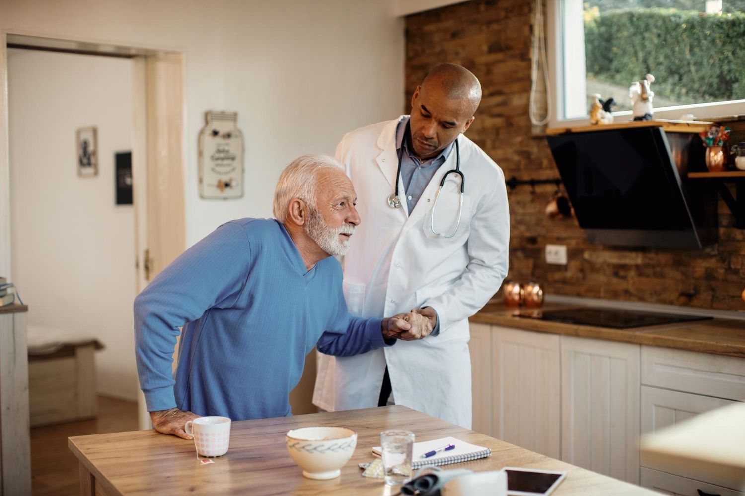 Caregiver and senior sharing coffee