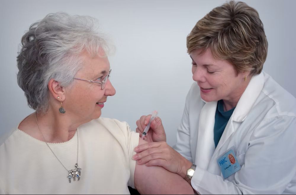 Caregiver talking happily with a senior
